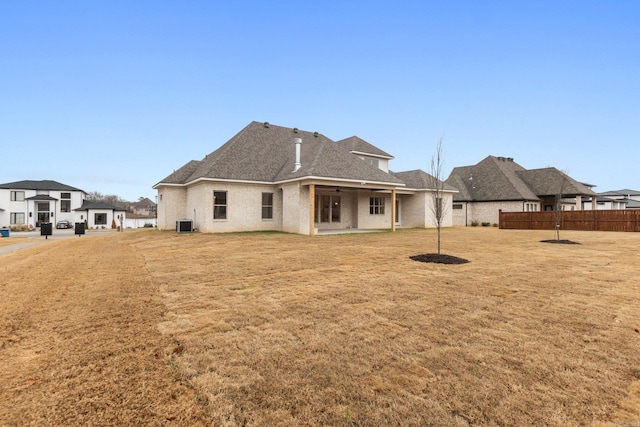 rear view of property featuring a lawn