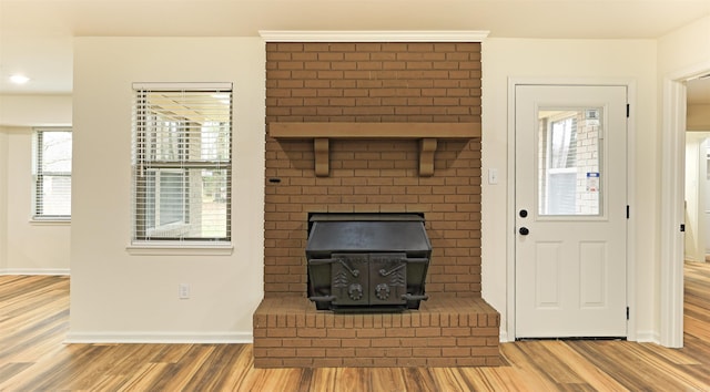 unfurnished living room with a wood stove and hardwood / wood-style floors