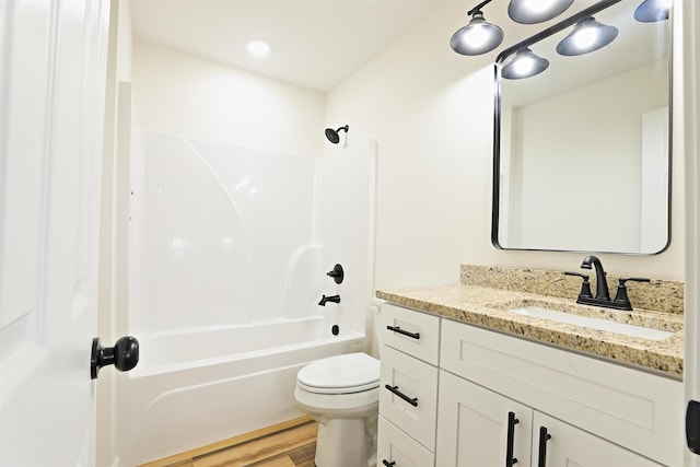 full bathroom with hardwood / wood-style flooring, vanity, toilet, and shower / bath combination