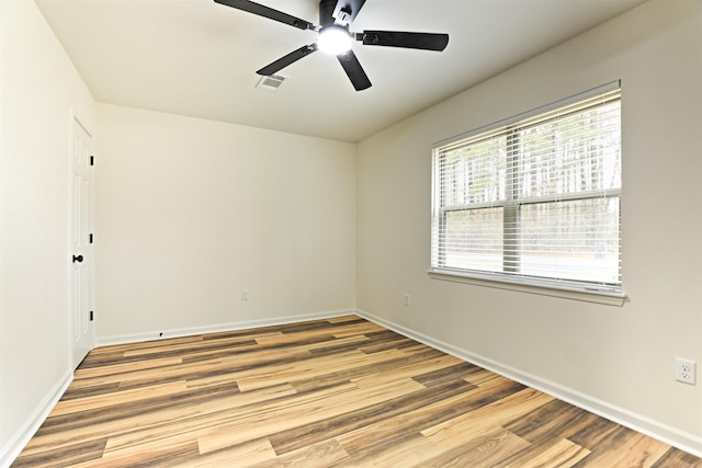 empty room featuring ceiling fan and light hardwood / wood-style floors