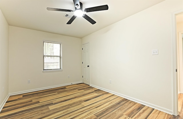 spare room with hardwood / wood-style floors and ceiling fan