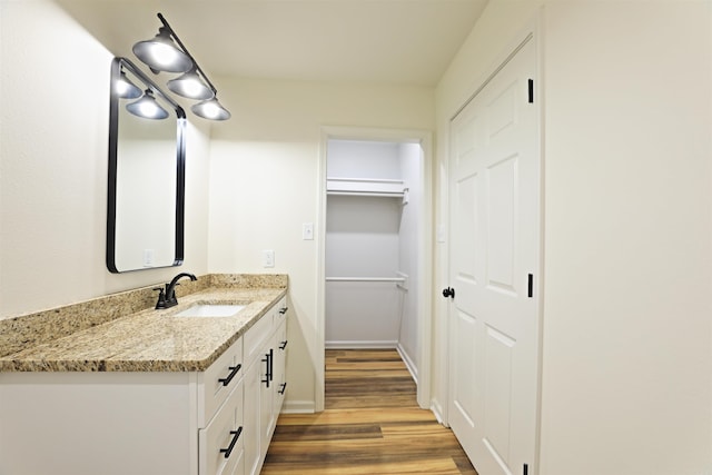 bathroom with hardwood / wood-style floors and vanity