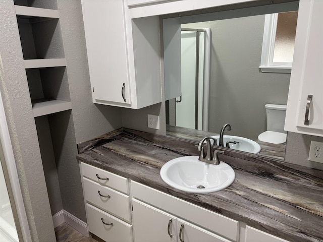 bathroom with hardwood / wood-style floors, vanity, and toilet