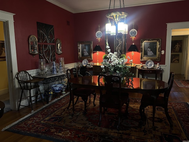 dining room featuring a chandelier, wood-type flooring, and crown molding