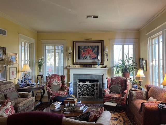 living room with a fireplace and ornamental molding