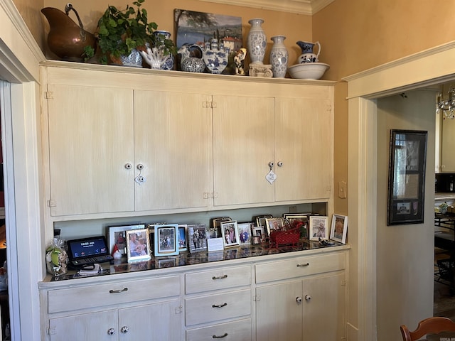 bar featuring ornamental molding and light brown cabinetry