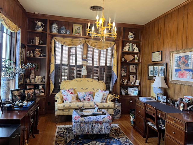 interior space with wood walls, dark hardwood / wood-style flooring, and a chandelier