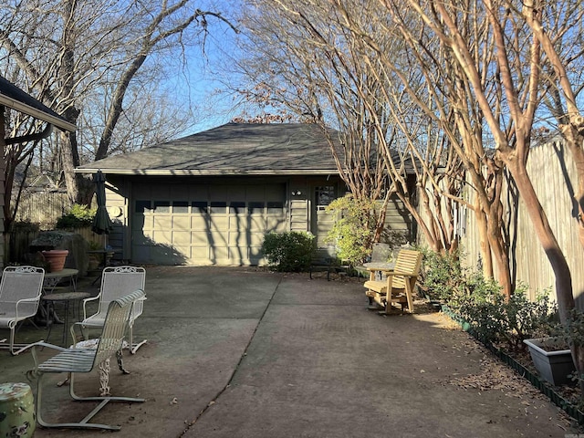 view of patio with an outdoor structure and a garage