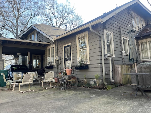 rear view of property with a carport