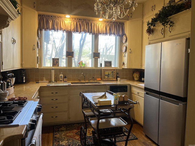 kitchen featuring stainless steel fridge, hardwood / wood-style flooring, a healthy amount of sunlight, and sink