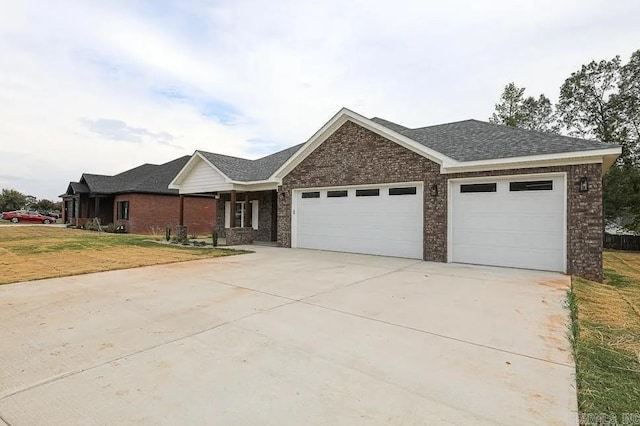 ranch-style house featuring a front yard and a garage