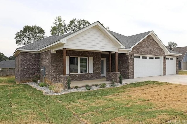 view of front facade with a garage, covered porch, and a front lawn