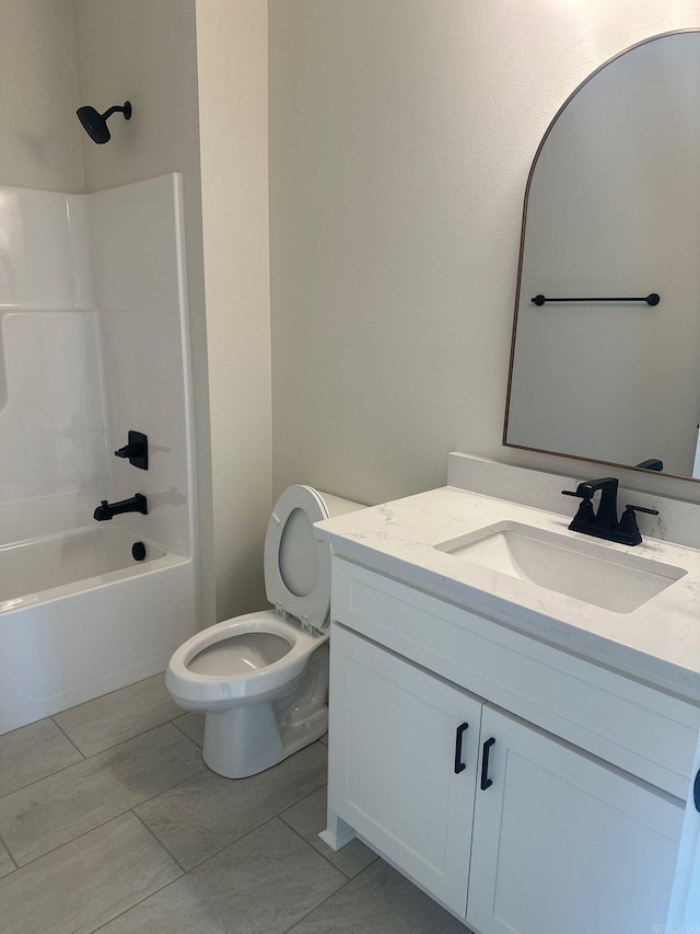 bathroom with vanity, shower / bathtub combination, and toilet
