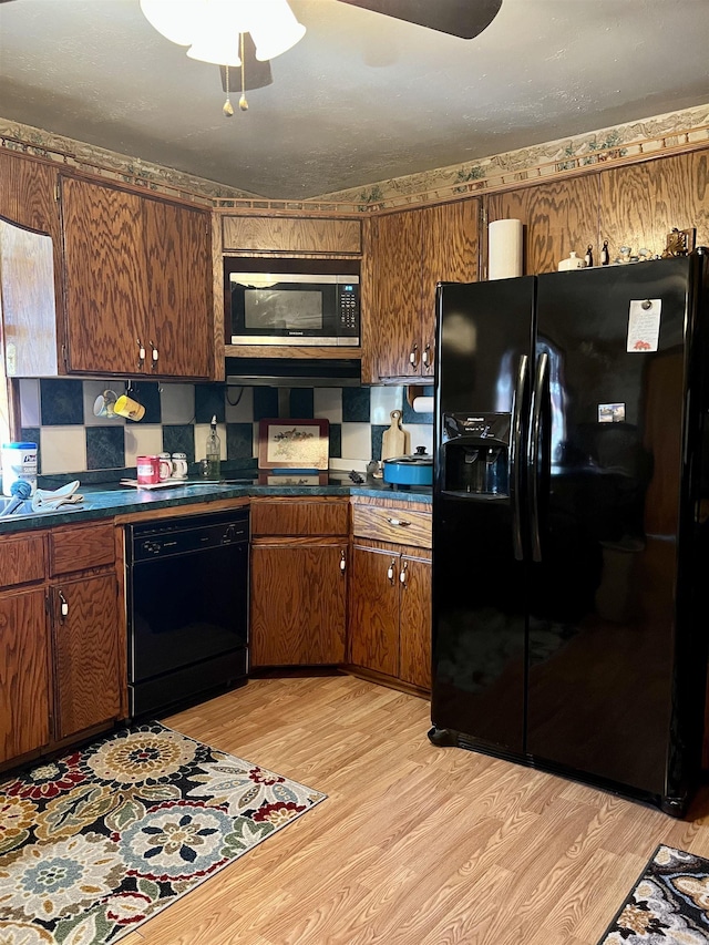 kitchen featuring light hardwood / wood-style floors and black appliances