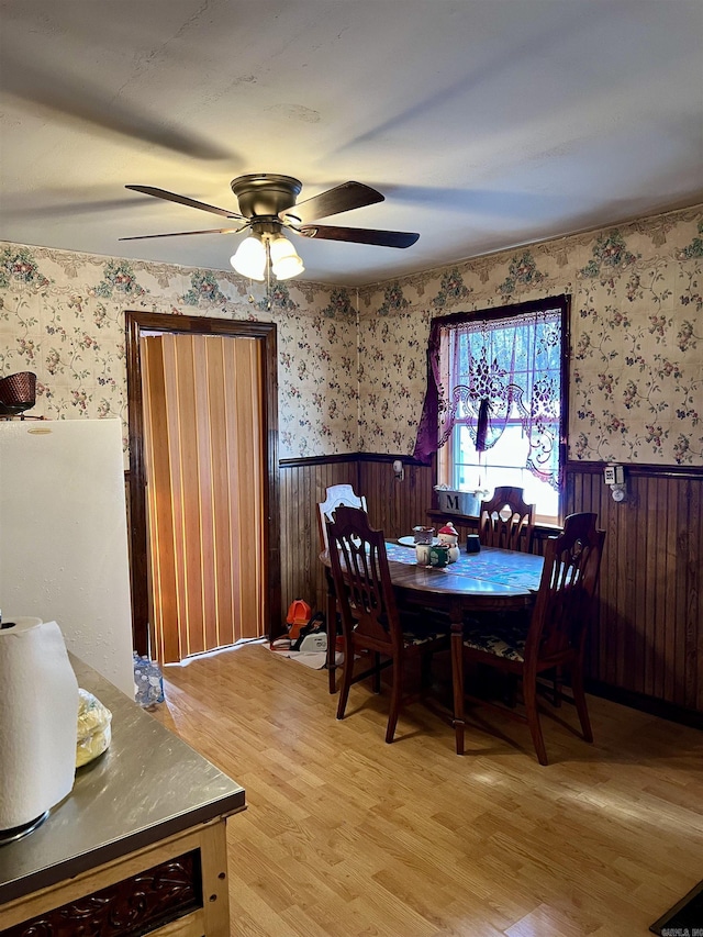 dining area with light hardwood / wood-style flooring and ceiling fan