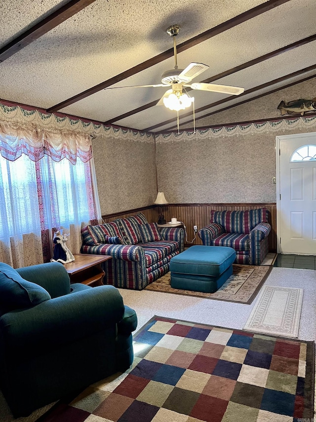 living room with carpet, ceiling fan, and a textured ceiling