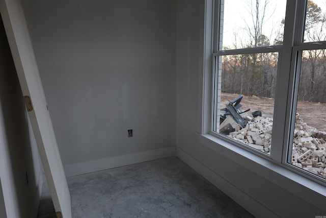 unfurnished room featuring concrete flooring and a wealth of natural light