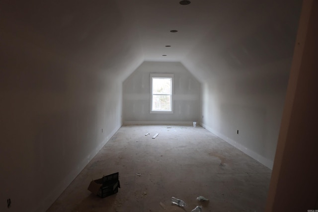 additional living space featuring vaulted ceiling