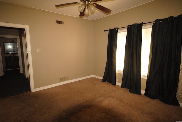 carpeted empty room with plenty of natural light and ceiling fan