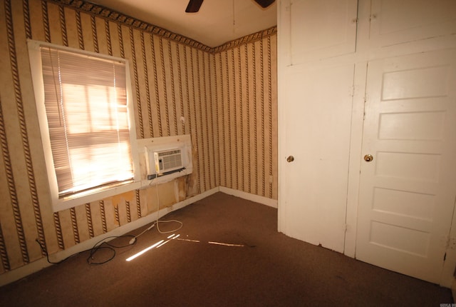 carpeted empty room with ceiling fan and a wall mounted air conditioner