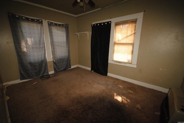 carpeted empty room featuring ceiling fan