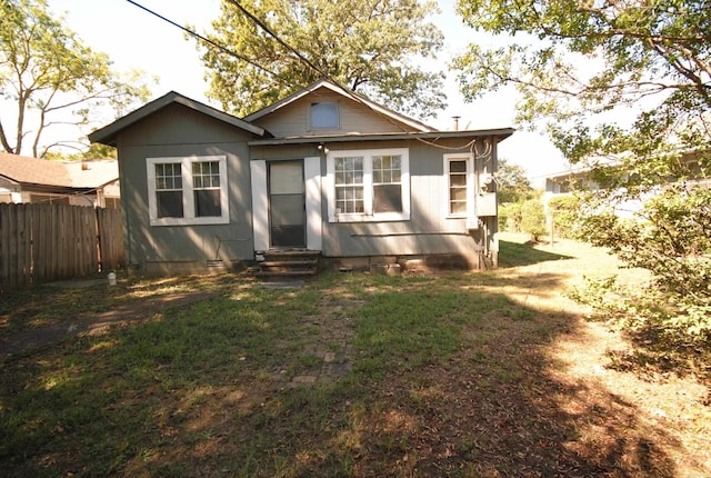 back of property featuring a lawn