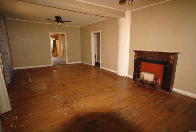 unfurnished living room with ornamental molding, ceiling fan, and dark wood-type flooring