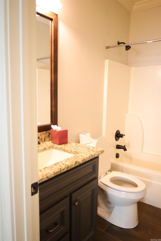 full bathroom with bathtub / shower combination, hardwood / wood-style floors, vanity, and toilet