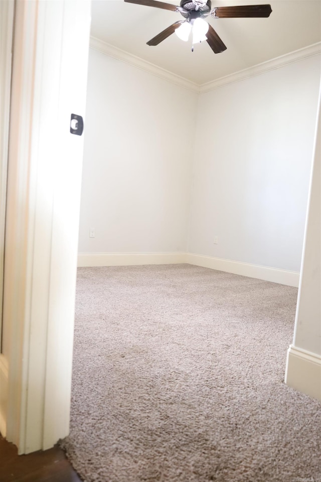 unfurnished room with carpet flooring, ceiling fan, and ornamental molding