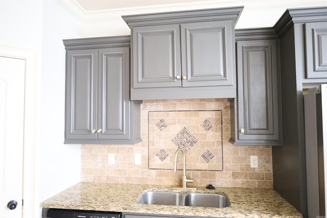 kitchen featuring tasteful backsplash, light stone counters, ornamental molding, sink, and dishwasher