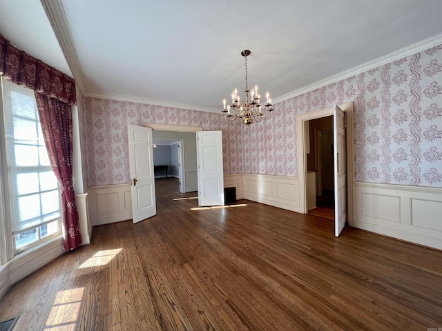 unfurnished dining area with a notable chandelier, dark hardwood / wood-style floors, and ornamental molding