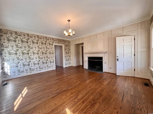 unfurnished living room featuring a chandelier, dark hardwood / wood-style flooring, and crown molding