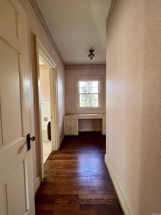 corridor with dark hardwood / wood-style flooring