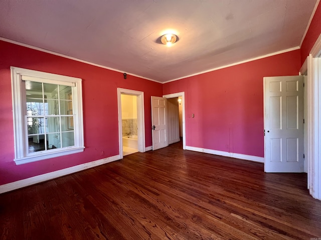 unfurnished bedroom featuring connected bathroom, dark hardwood / wood-style floors, and crown molding