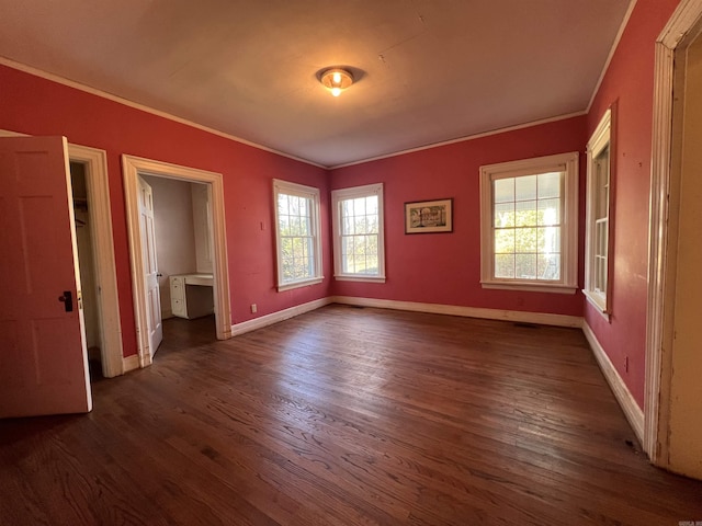 unfurnished bedroom featuring dark hardwood / wood-style flooring and ornamental molding