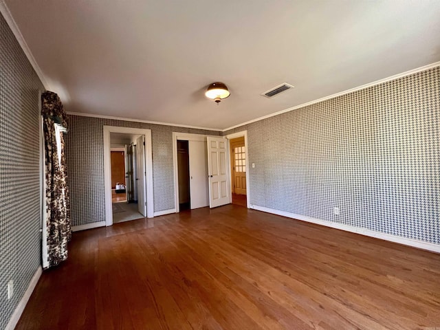 unfurnished bedroom with hardwood / wood-style flooring and ornamental molding