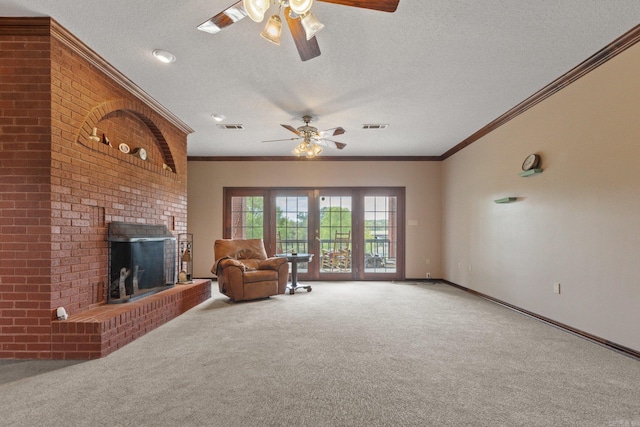 unfurnished living room with carpet flooring, a brick fireplace, ornamental molding, a textured ceiling, and ceiling fan