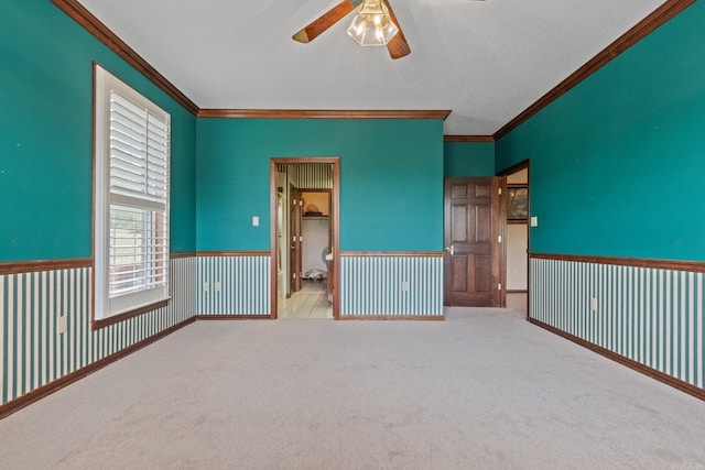 unfurnished room featuring light carpet, ceiling fan, and ornamental molding