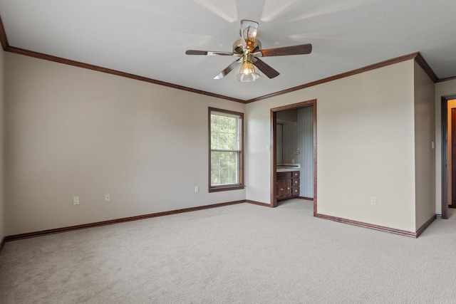 carpeted spare room featuring ceiling fan and ornamental molding