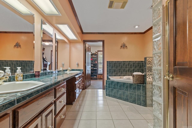 bathroom with tile patterned flooring, a relaxing tiled tub, ornamental molding, and vanity