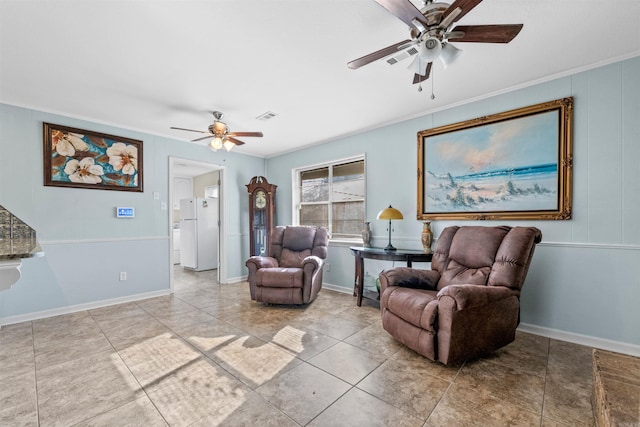 living area featuring ceiling fan and crown molding