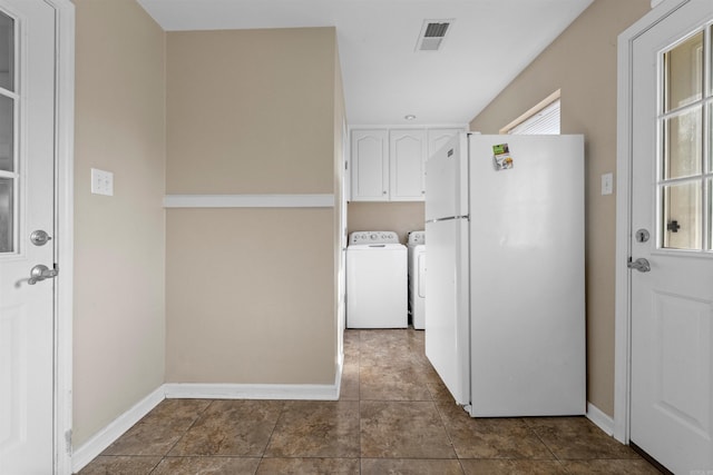 washroom with cabinets and separate washer and dryer