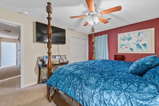 carpeted bedroom with ceiling fan and a closet