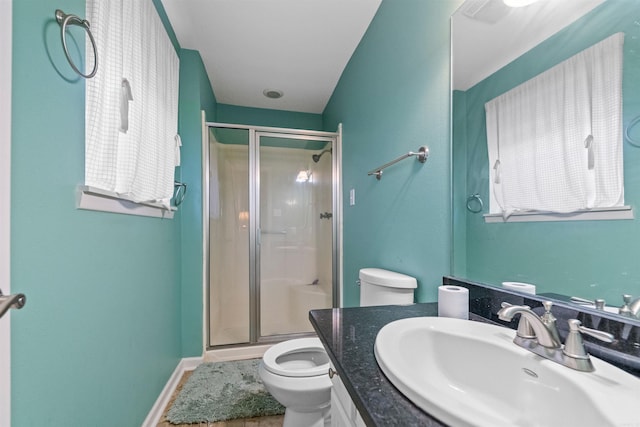 bathroom featuring walk in shower, tile patterned flooring, vanity, and toilet