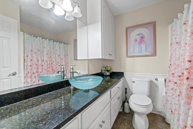 bathroom featuring tile patterned floors, vanity, and toilet