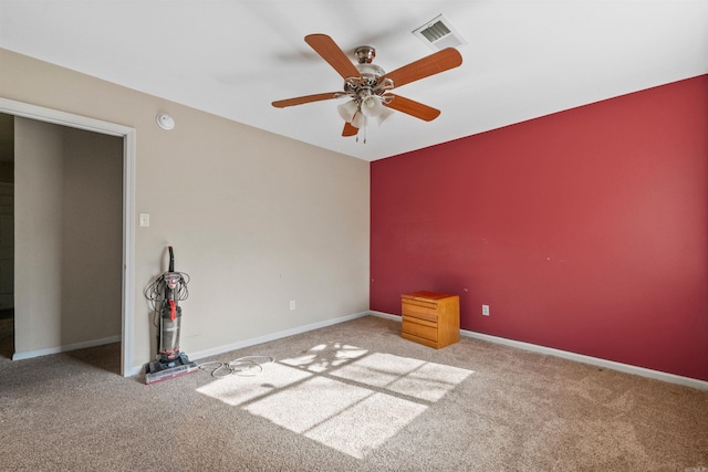 unfurnished room featuring light carpet and ceiling fan