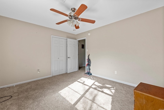 unfurnished bedroom with carpet, ceiling fan, and a closet