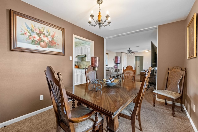 dining area with ceiling fan with notable chandelier and carpet floors