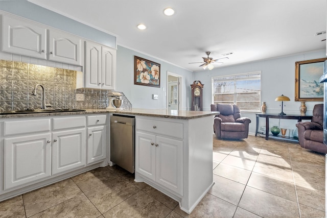 kitchen with sink, stainless steel dishwasher, ceiling fan, white cabinetry, and kitchen peninsula