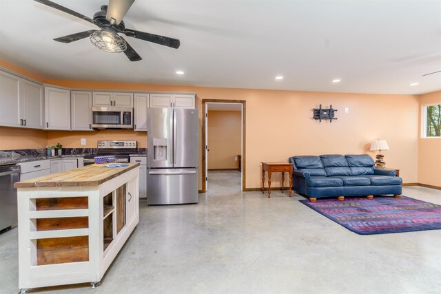120 Needham Rd, Fountain Lake, AR 71901 - kitchen featuring butcher block countertops, baseboards, open floor plan, a ceiling fan, and stainless steel appliances